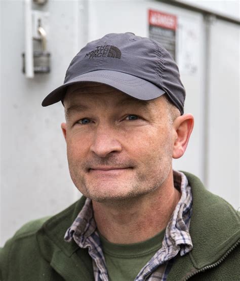 A man wearing baseball cap and flease sweatshirt